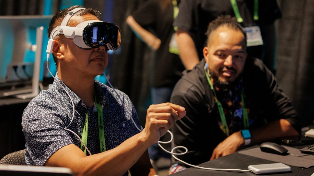 An image of two men testing PITAR with a VR headset sitting at a table